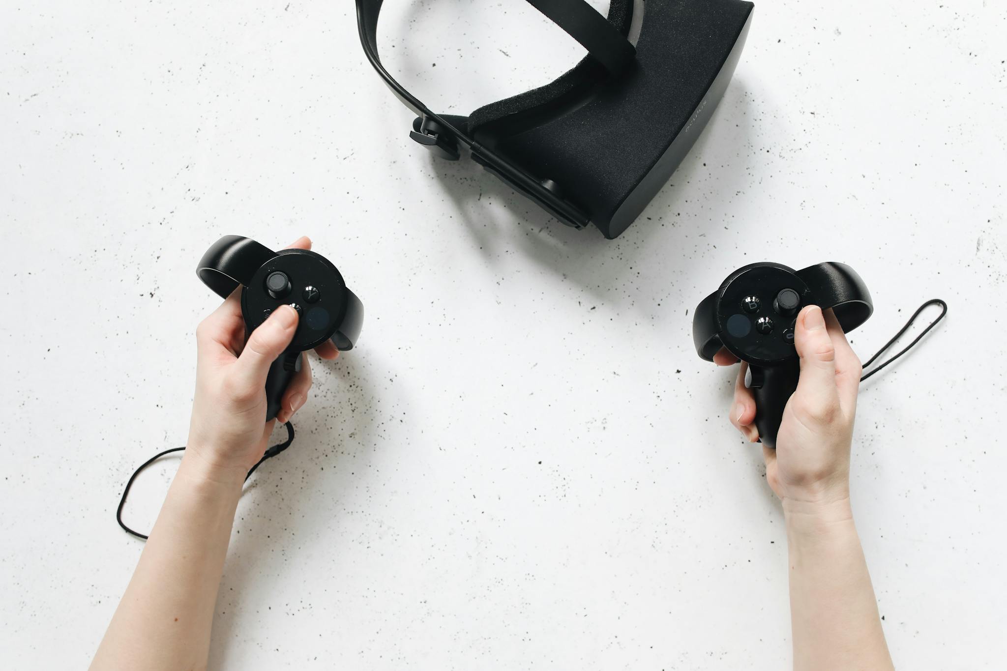 Hands holding VR controllers